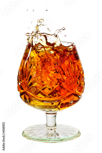 snifter glass full to the brim with brandy and splash photo