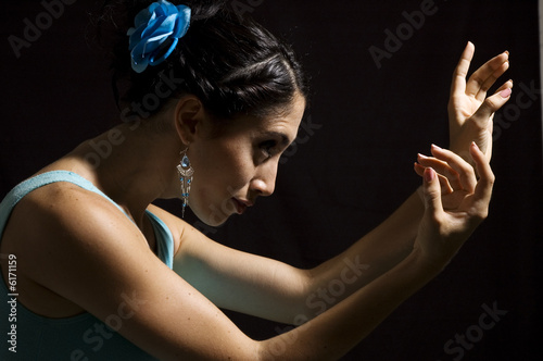 Passionate flamenco dancer girl isolated on black