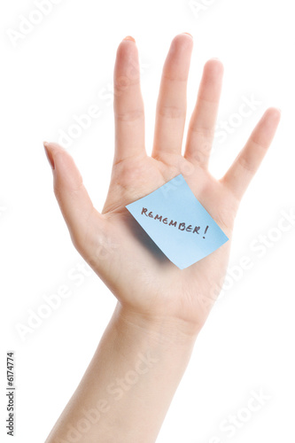 Isolated female hand with the sticky note photo
