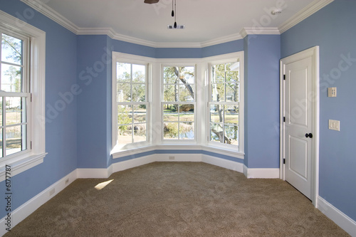 Fotografie blue bedroom with lots of windows looking out onto pond