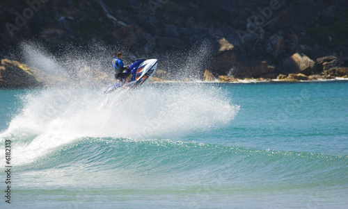 jetskier does amazing jump out of surf wave. 