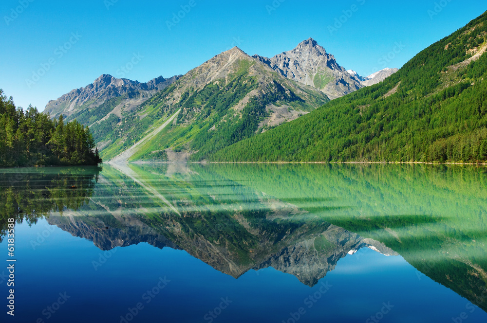 Landscape with mountains reflected in quiet lake