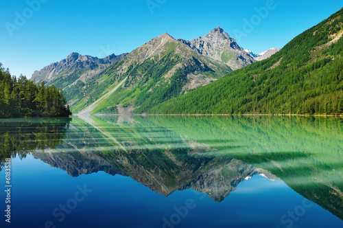 Landscape with mountains reflected in quiet lake