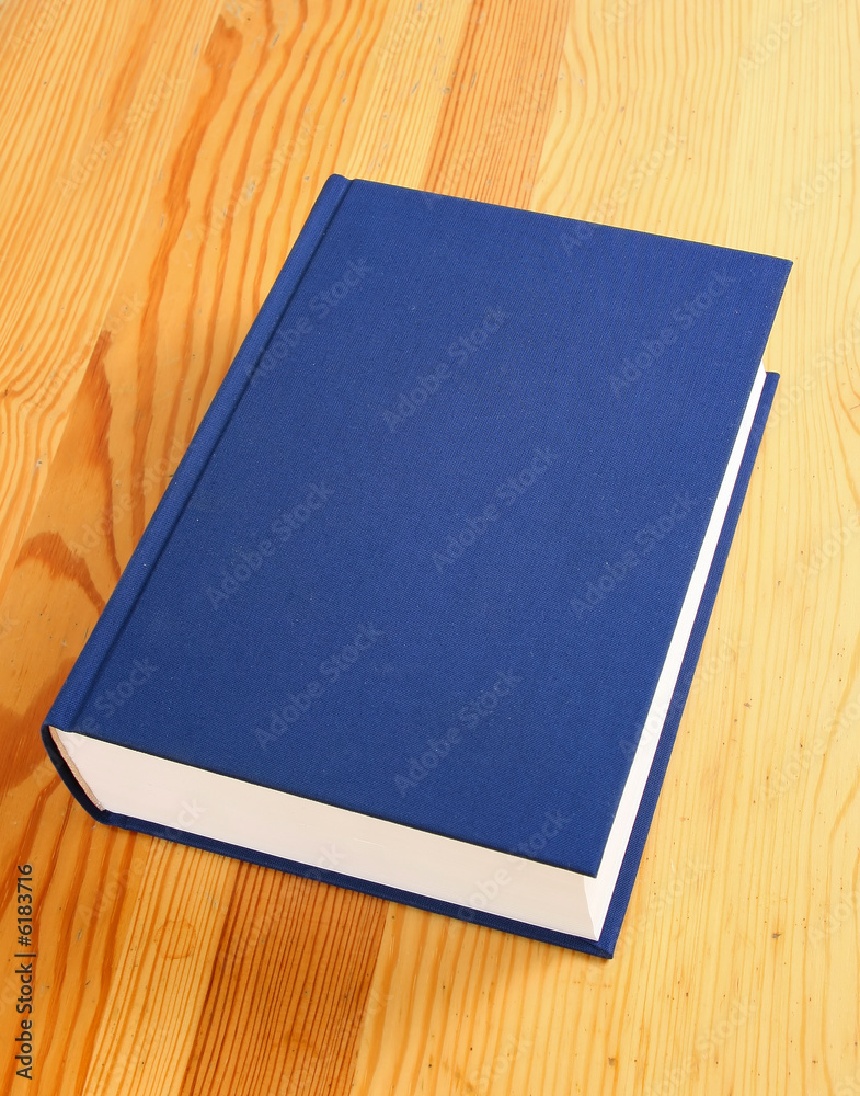 single navy blue book over wooden background single navy blue book over wooden background