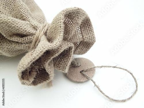 The part of the close beige linen sack with the tag label