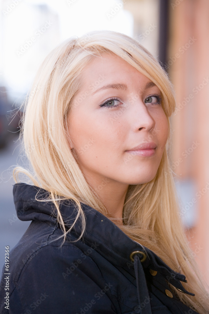 Fototapeta premium Smiling young woman in urban location