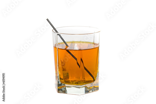 Isolated cut glass filled with a strong whiskey drink