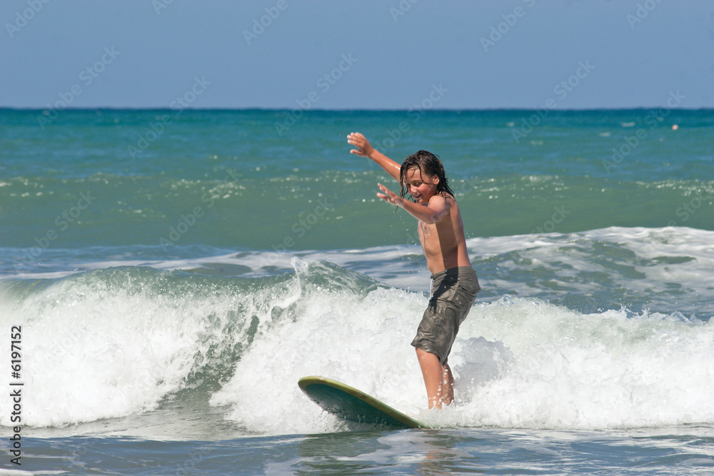 A young caucasian male learns to surf 