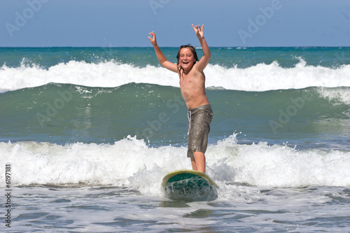 A young caucasian male learns to surf