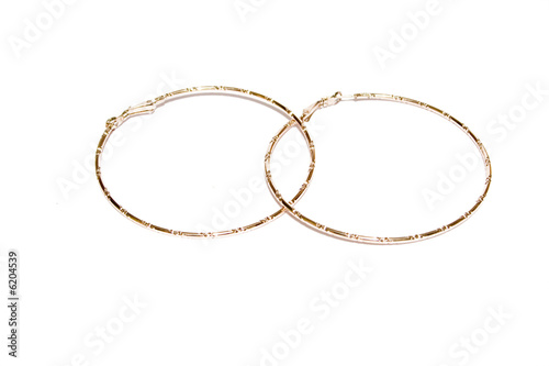 golden ear-rings on the white isolated background