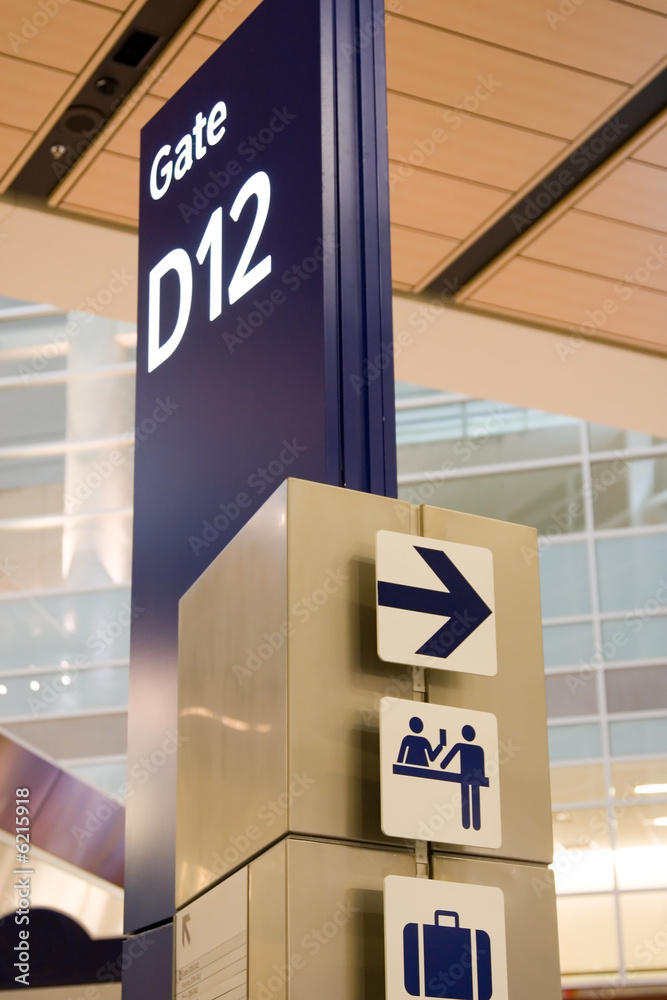 Direction signs in an airport terminal for travelers Direction signs in an airport terminal for travelers