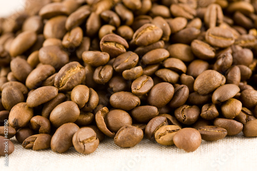 heap of coffee beans on sacking background