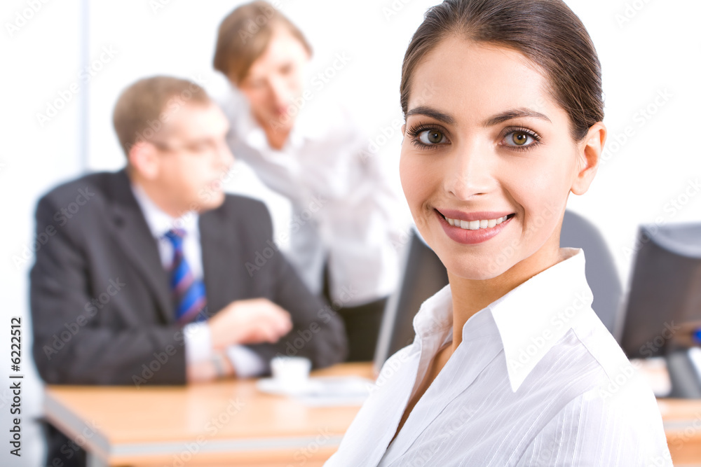 Face of beautiful lady on the background of her colleagues Face of beautiful lady on the background of her colleagues