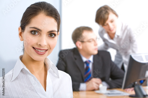 Strong woman on the background of business people