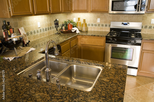 Luxury home kitchen with a granite island.