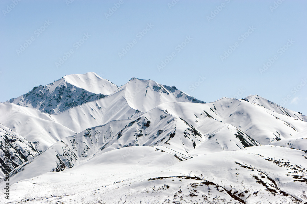 Snow covered mountain peaks during winter