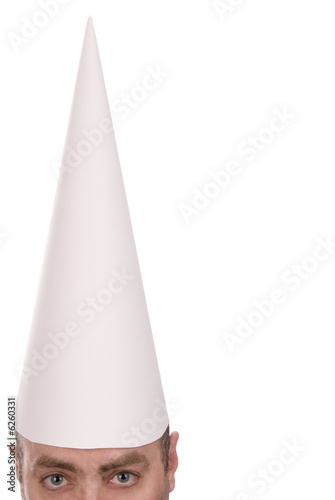 Man in a dunce cap over a white background