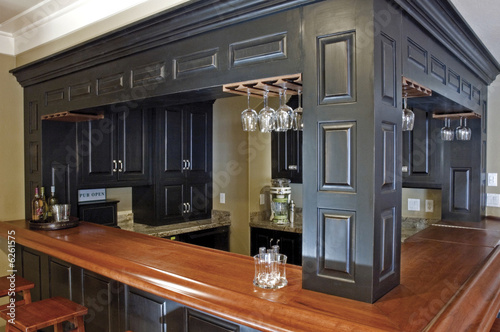 Фотография Custom-built bar and wood cabinetry