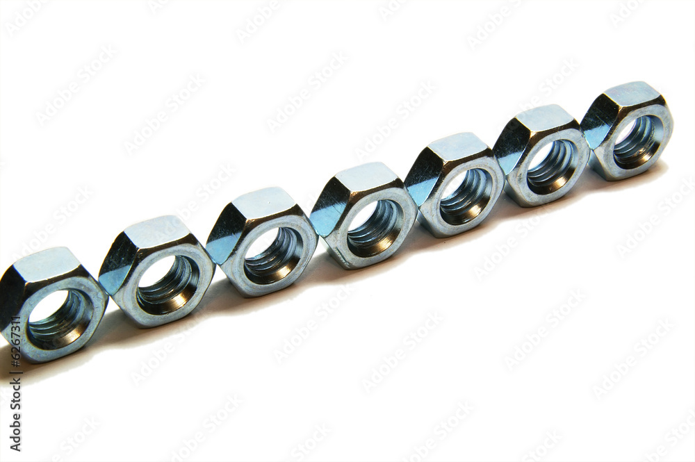 Seven screw-nuts, line, isolated, close up, macro, inclidence Seven screw-nuts, line, isolated, close up, macro, inclidence