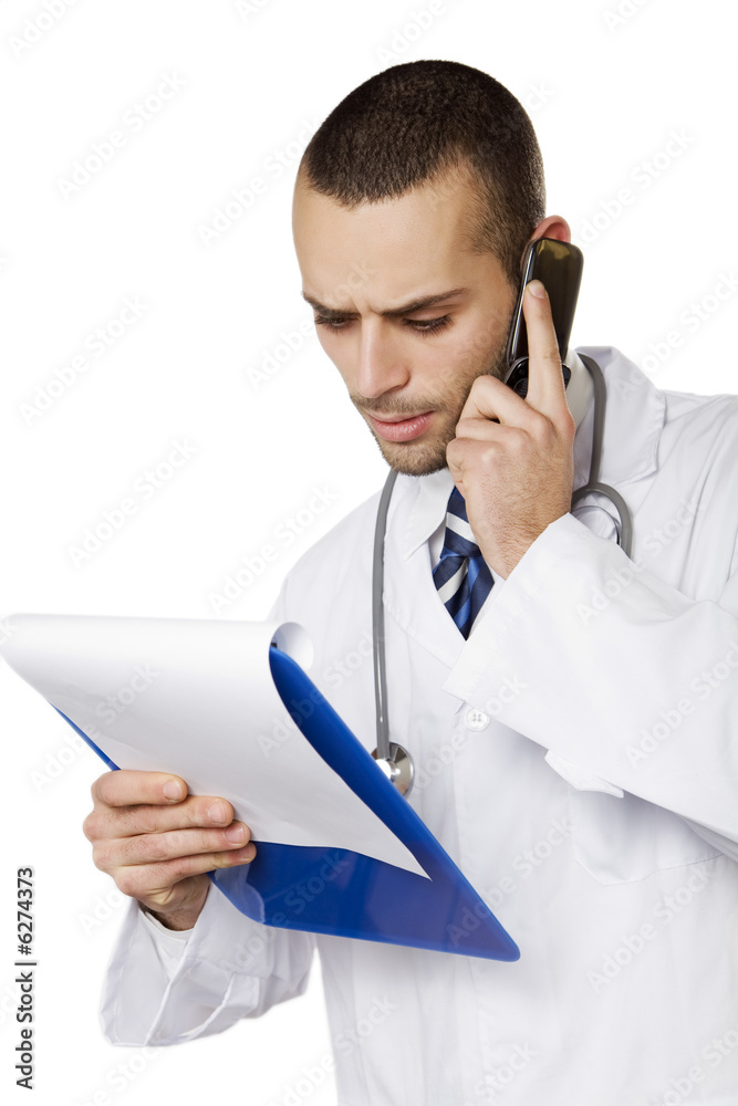 healthcare and medicine: young doctor talking on the phone healthcare and medicine: young doctor talking on the phone
