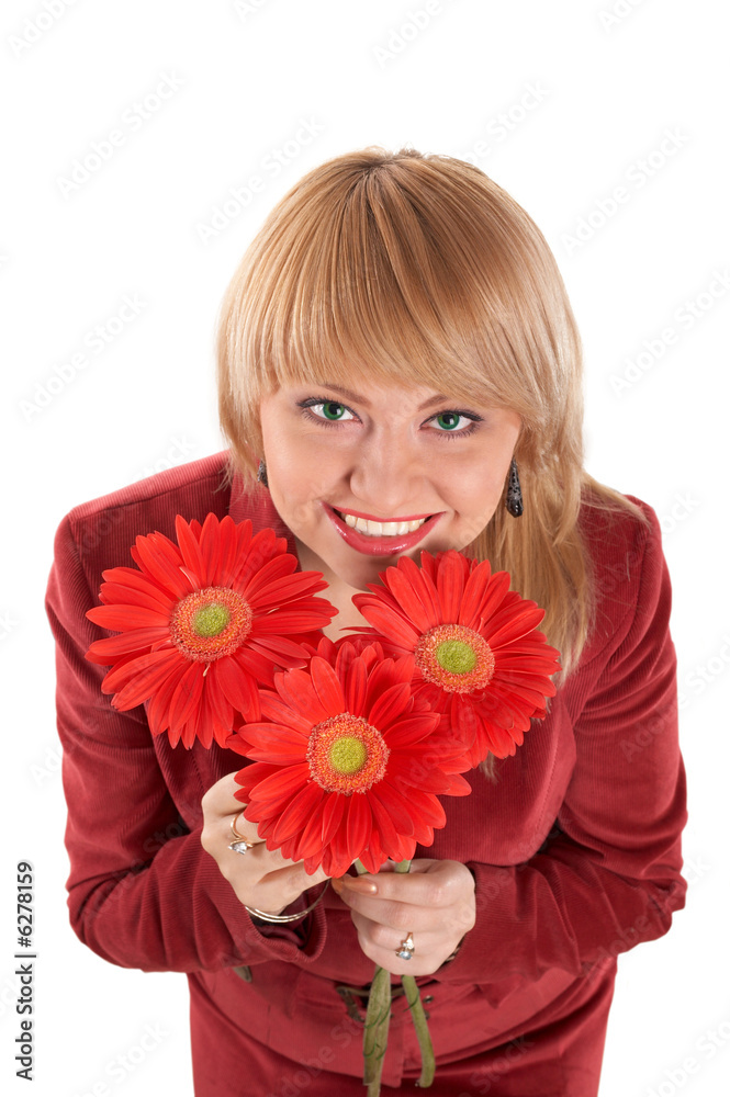 A smiling green-eyed woman with red flowers A smiling green-eyed woman with red flowers