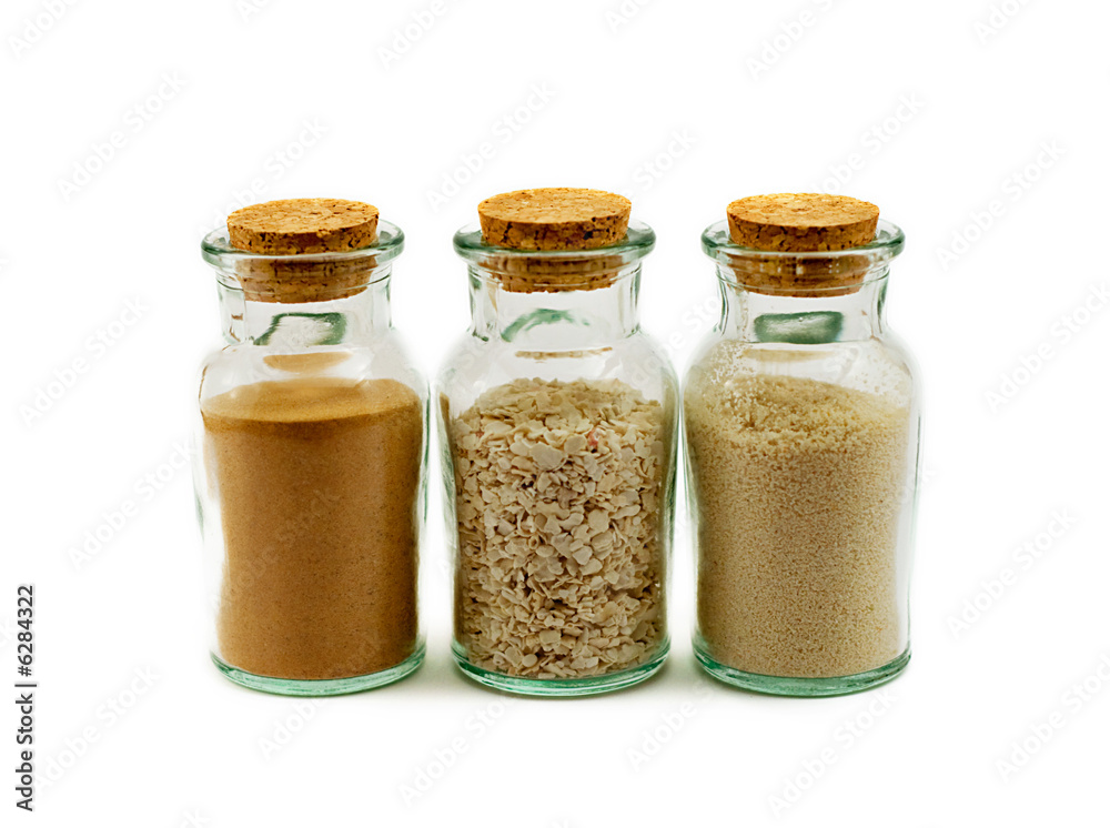 three glass bottles filled with sand three glass bottles filled with sand