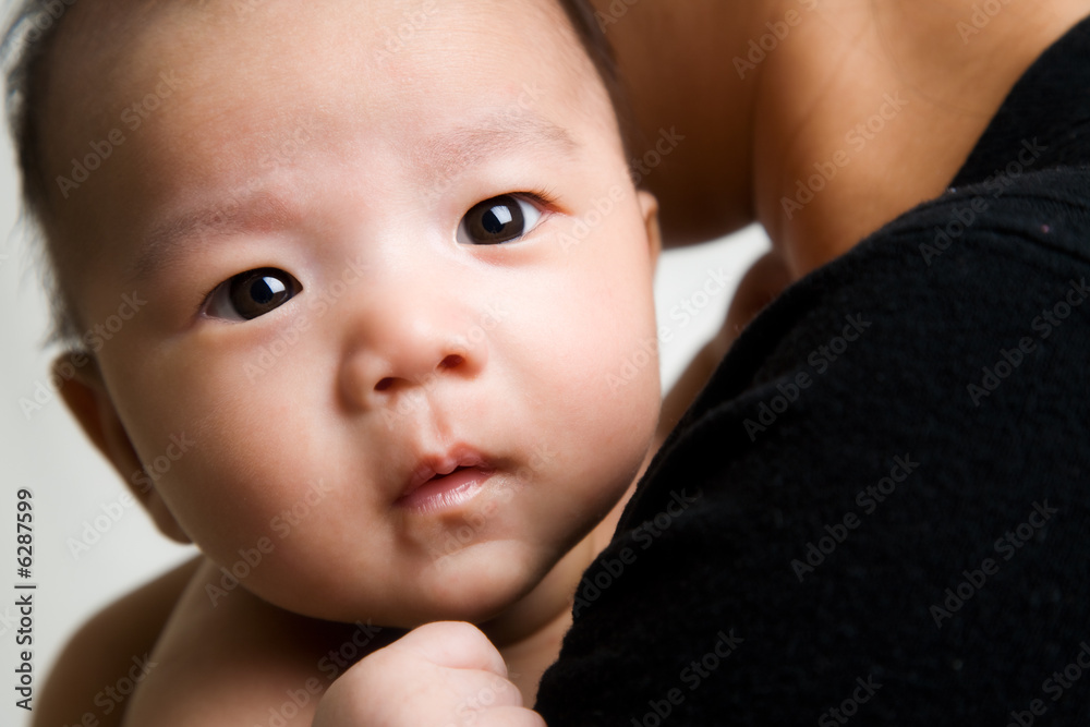 A shot of an asian mother with her cute baby A shot of an asian mother with her cute baby