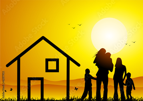 Happy family with house at sunset