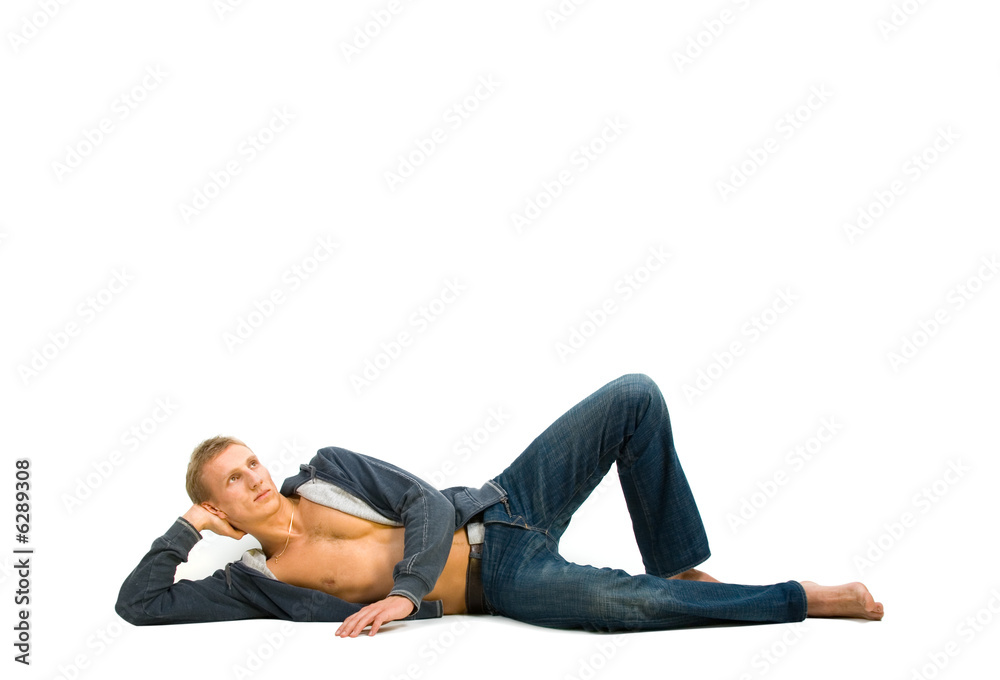 Young man lying and dreaming on isolated background Young man lying and dreaming on isolated background