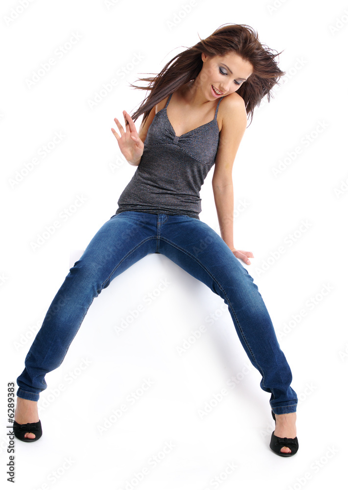 sexy woman in jeans sitting on the white table Stock Photo | Adobe Stock