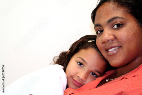 Mom and daughter on white b...