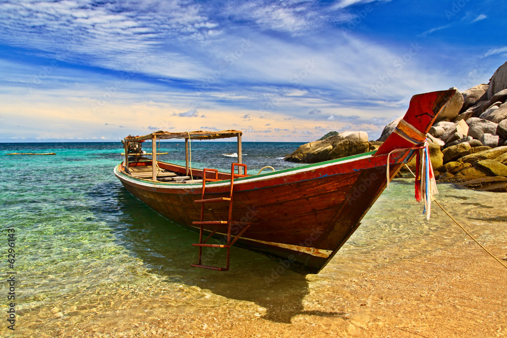 Longtail boat in tranquil bay