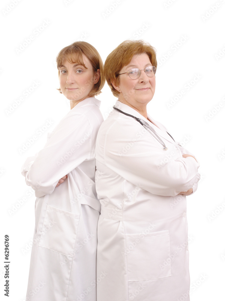 Female young and senior doctors standing back-to-back