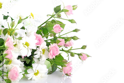 Bouquet flowers of a rose and camomiles on white background