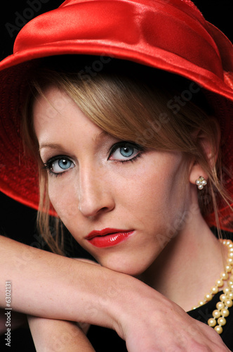 Close up portrait of beautiful young woman with red hat