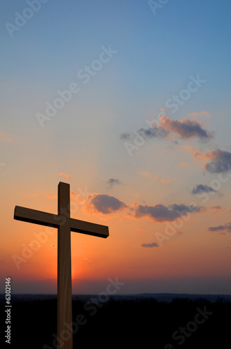 Wooden cross suring a colorful sunset