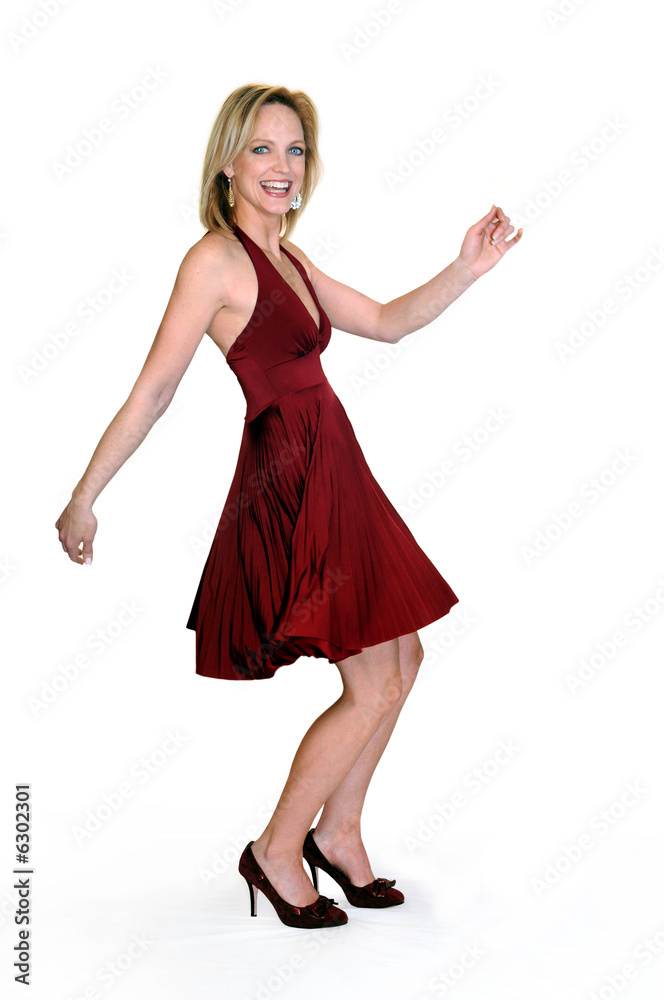 Fototapeta premium Young woman expressing joy dancing over a white background