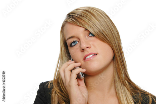 Beautiful teen girl on the cell phone on a white background