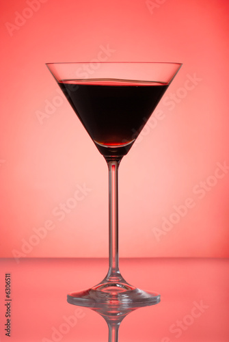 Pomegranate cocktail on red background