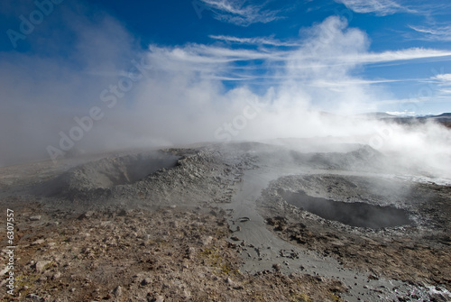 mud geyser over blue sky, altiplano, bolivia