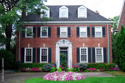 house with dormer windows and impatiens