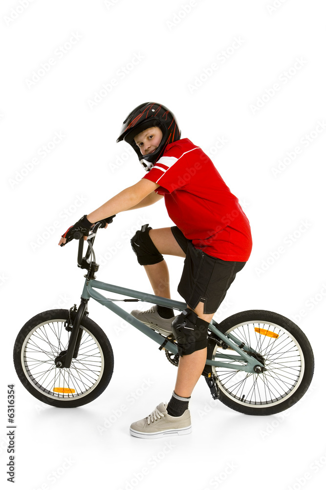 Happy boy in helmet on BMX and looking at camera Happy boy in helmet on BMX and looking at camera
