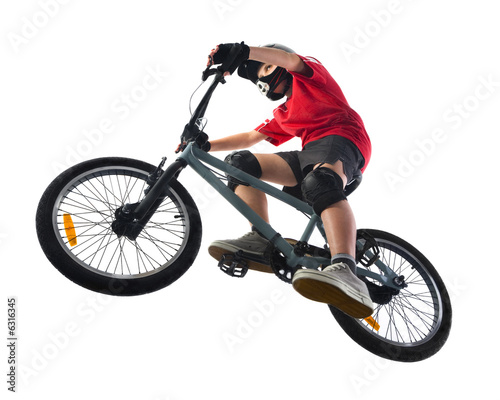 Young boy in red T-shirt cycling on BMX