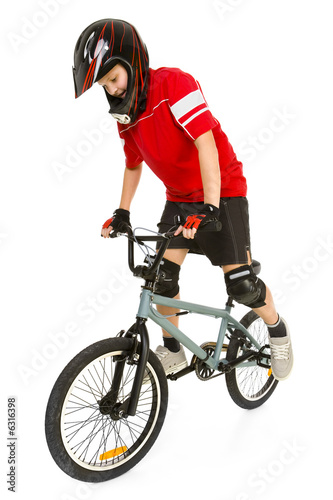Fototapeta Naklejka Na Ścianę i Meble -  Young boy in red T-shirt cycling on BMX