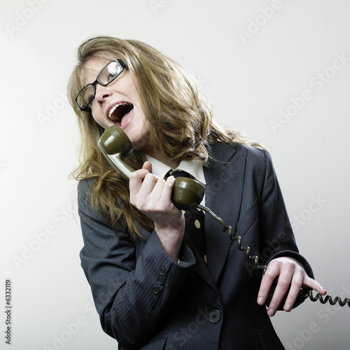 Woman laughing at telephone photo