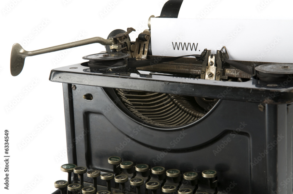 An old ancient typewriter is used to type an internet address. 