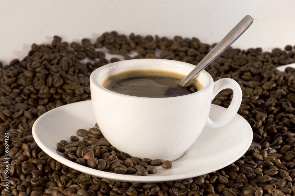Cup of coffee and coffee beans background Cup of coffee and coffee beans background