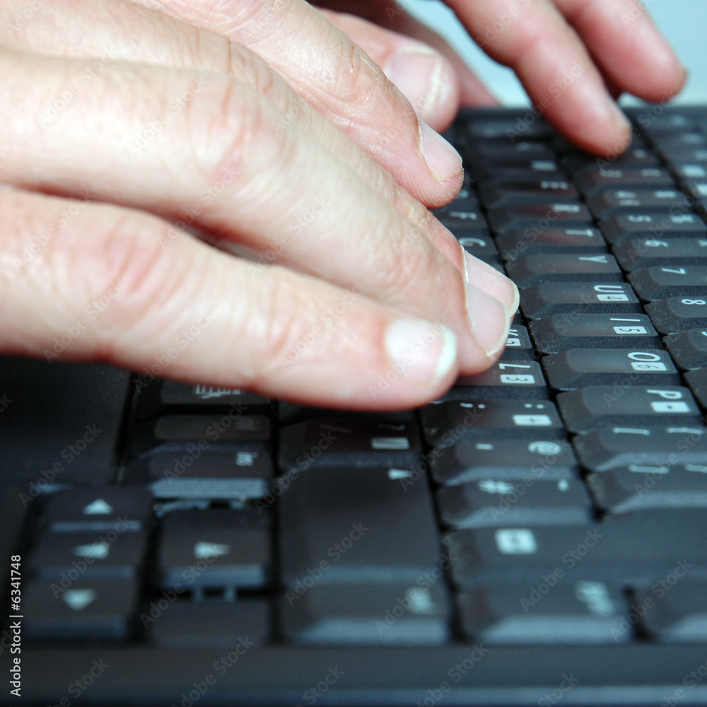 Closeup of hands typing on a laptop keyboard. Closeup of hands typing on a laptop keyboard.