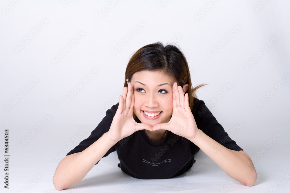 expressive girl with palm out on her face lying on the floor expressive girl with palm out on her face lying on the floor