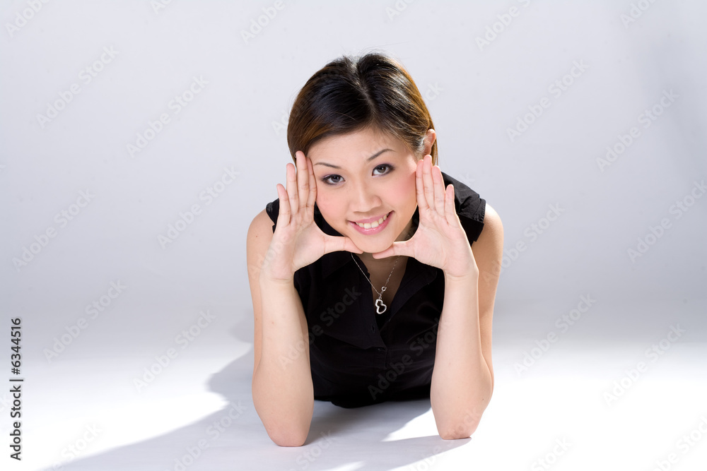 expressive girl with palm out on her face lying on the floor expressive girl with palm out on her face lying on the floor